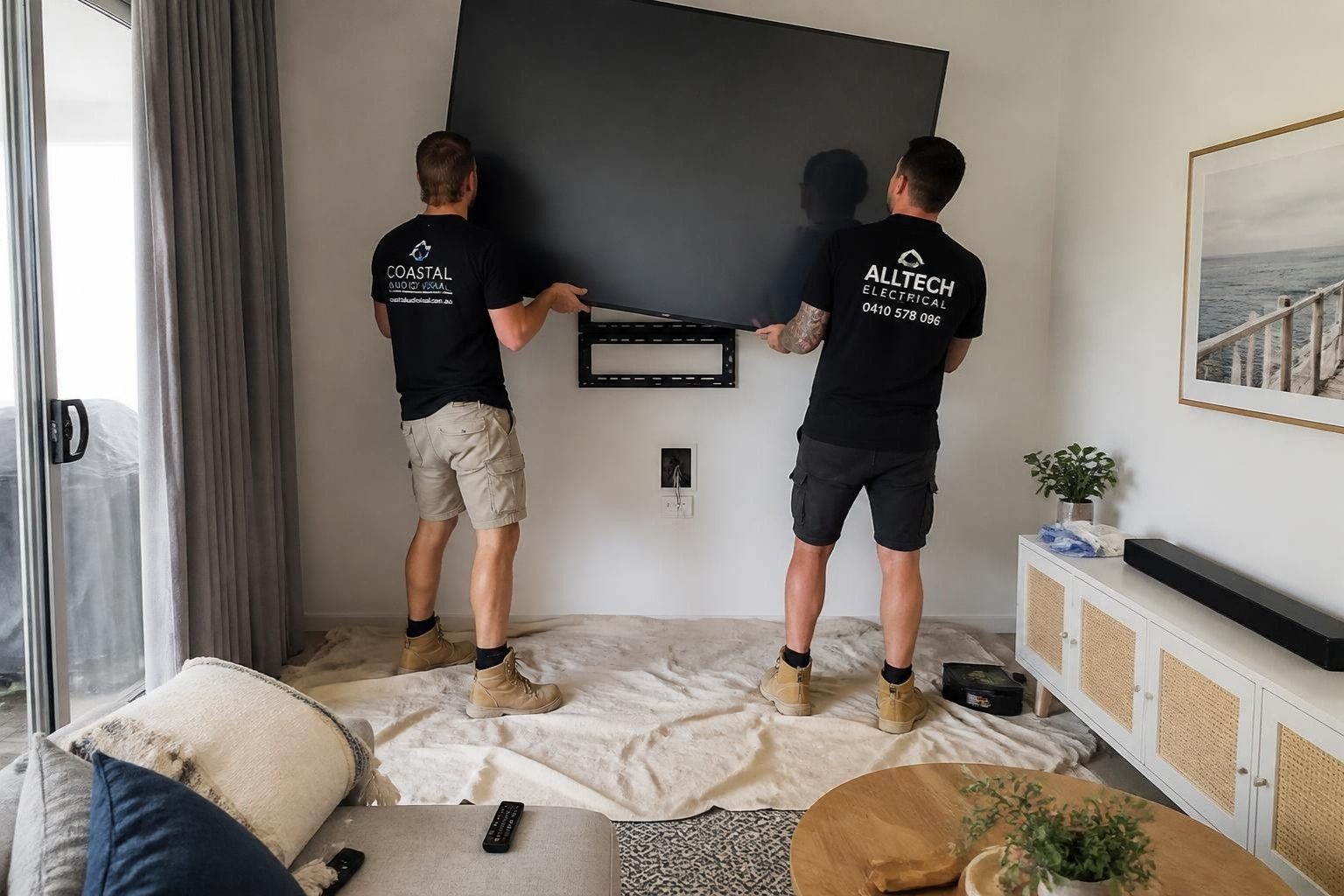 Lifting the TV onto its wall bracket